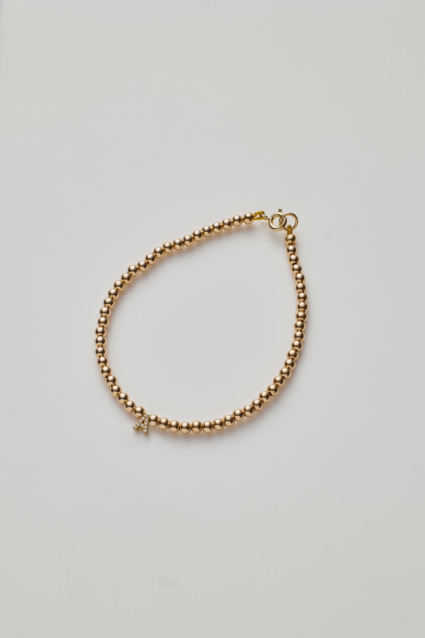 One Diamond Letter Gold Beaded Bracelet