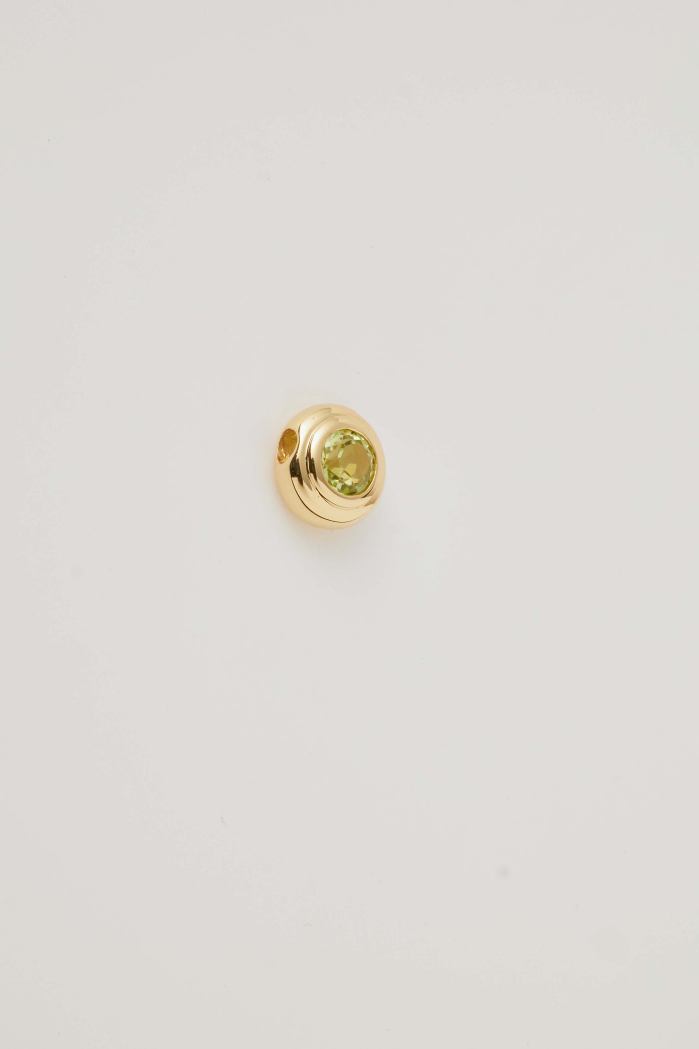 Side view image of the August Birthstone Charm featuring a vibrant peridot gemstone in a sleek setting, radiating a bright green hue. A symbol of joy and growth, perfect for celebrating August birthdays."