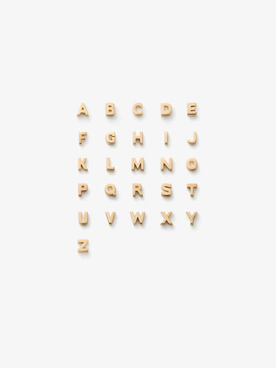 A grid of 18k solid gold alphabet letters. The letter charms are arranged in alphabetical order on a white background from A to Z