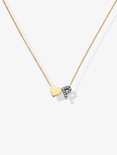 A gold necklace named "One Heart and Letter in Diamonds and 18k Blackened Gold" features a delicate chain with a pendant consisting of a solid 18k blackened gold heart and the letter "P" adorned with small white diamonds. The necklace casts a faint shadow on a white background.