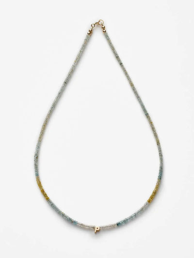 The One Letter Necklace in Aquamarine and 18k Gold features a thin, multicolored beaded chain adorned with delicate Aquamarine gemstones and a small gold pendant in the shape of the letter "P." The 18k gold chain necklace is displayed against a white background.