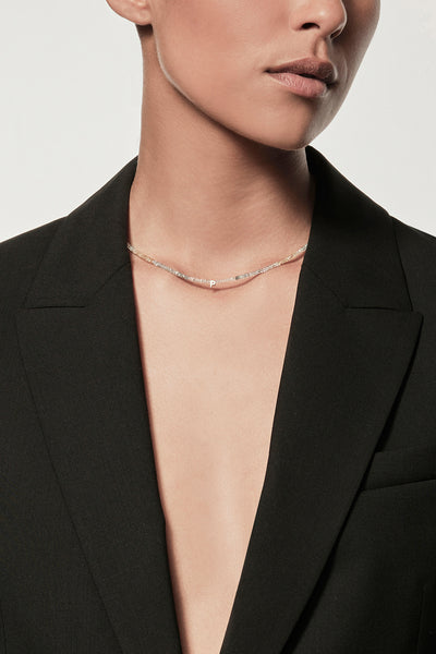 Women wearing a black blazer and Faceted aquamarine beaded collier necklace with gold accents on silk thread