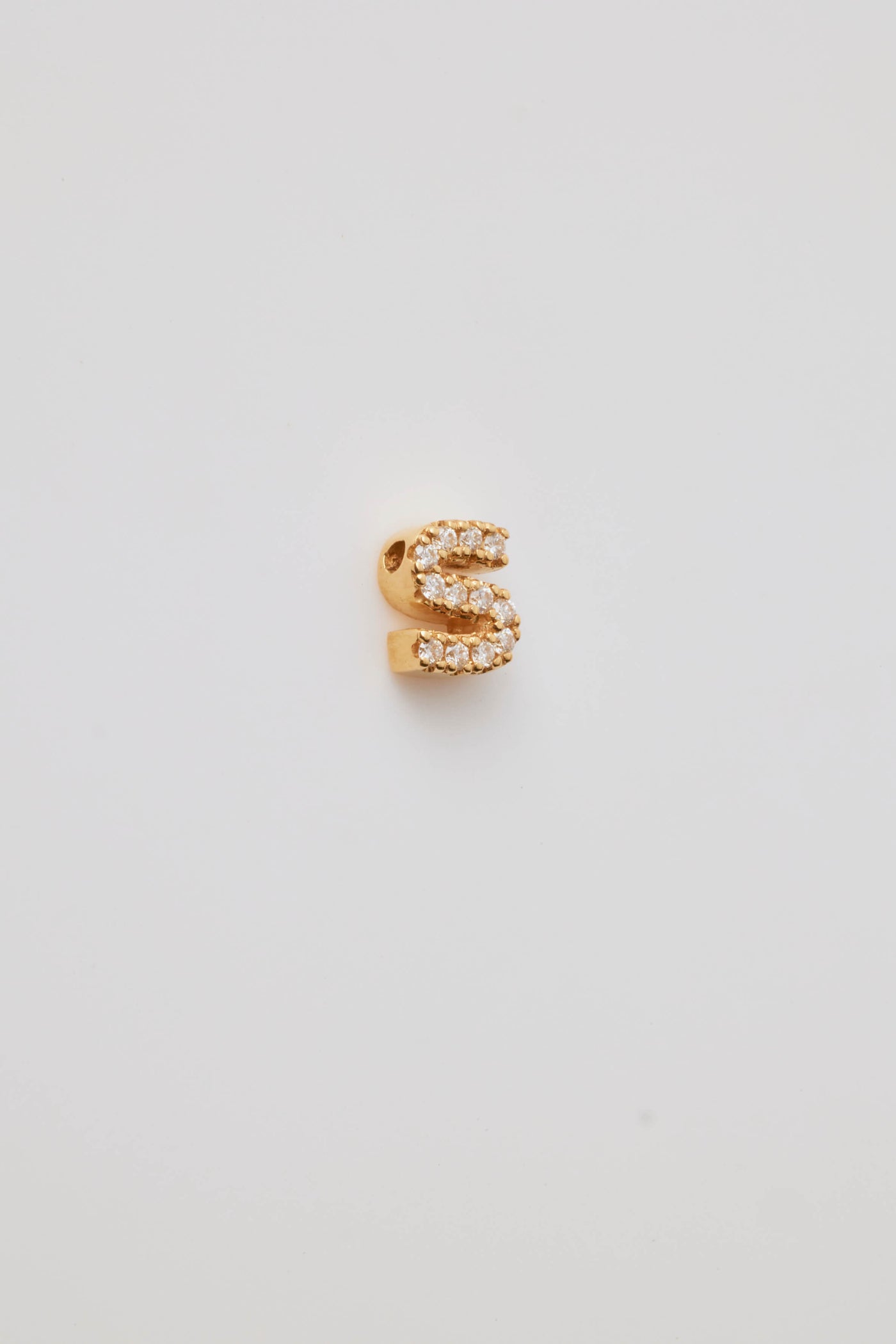 Small solid gold three-dimensional letter 'S' charm with pavé set diamonds, designed to thread onto a necklace chain.