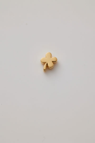 Solid gold four-leaf clover charm representing luck, hope, faith, and love, designed to slide onto a necklace chain for a timeless keepsake.