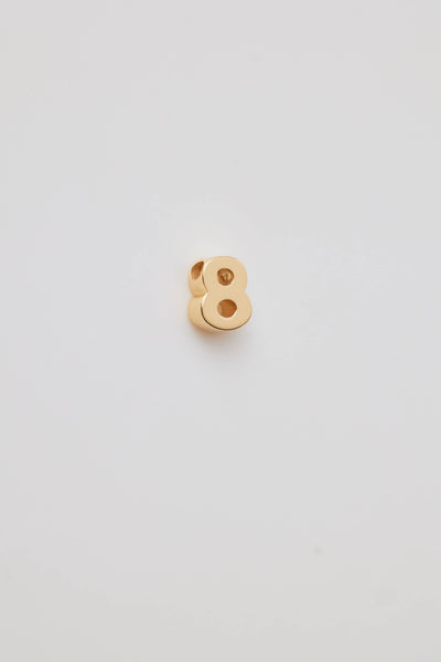 Small solid gold number charms (0-9), designed to slide onto a necklace chain for a personalised jewellery piece with symbolic meaning.