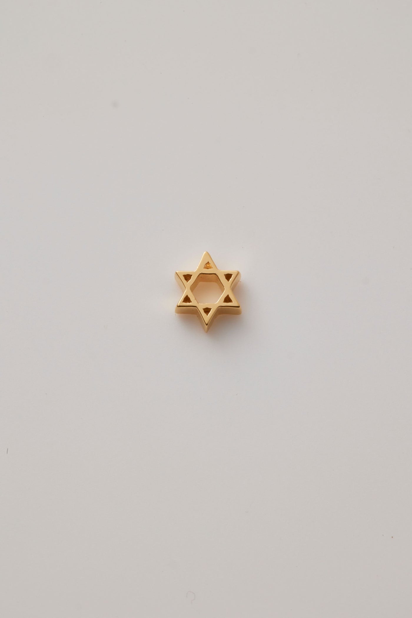 Small solid gold Star of David charm, designed to slide onto a necklace chain for a personalised jewellery piece.