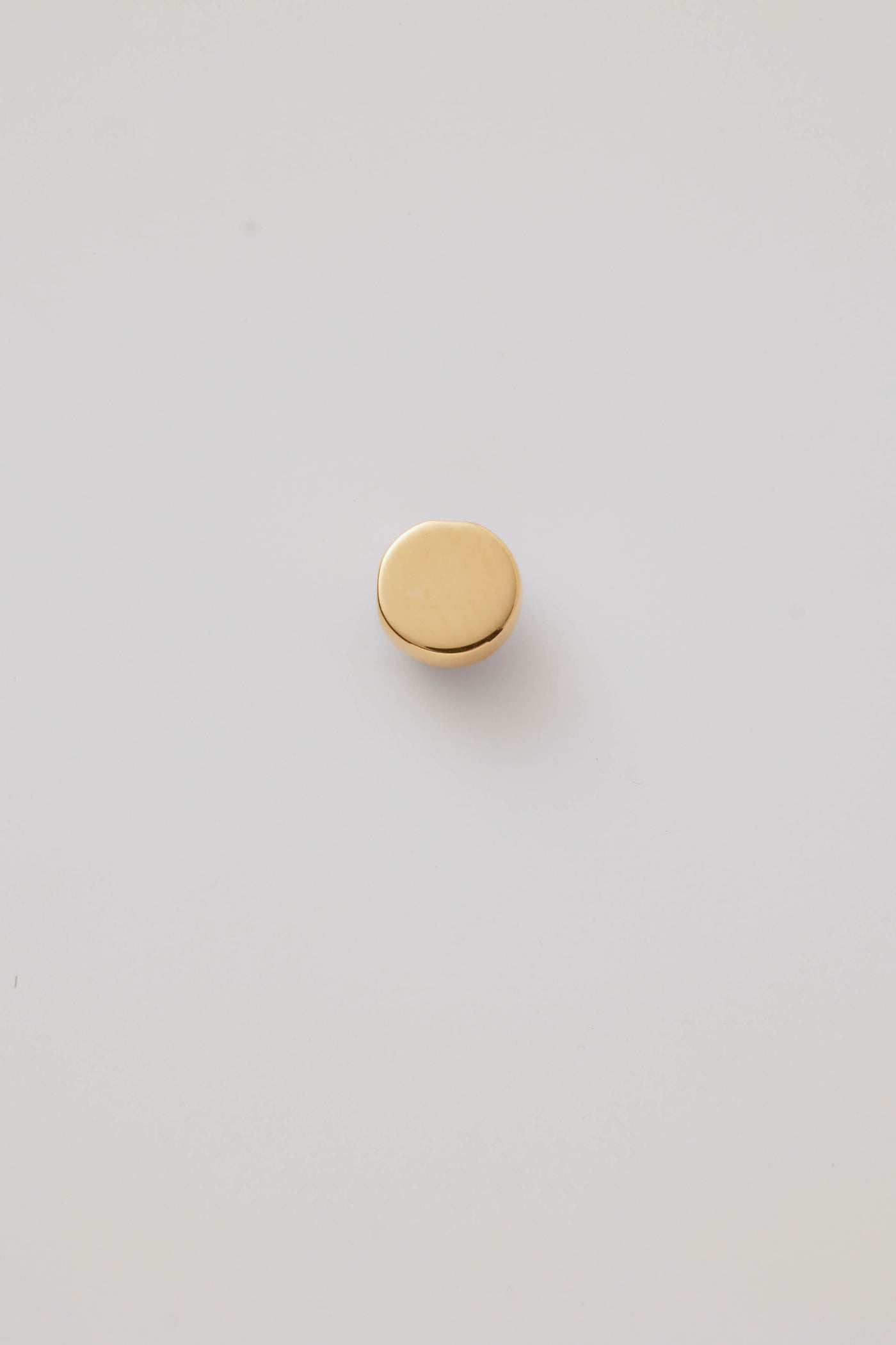 Small solid gold evil eye charm, designed to slide onto a necklace chain for a personalised jewellery piece.