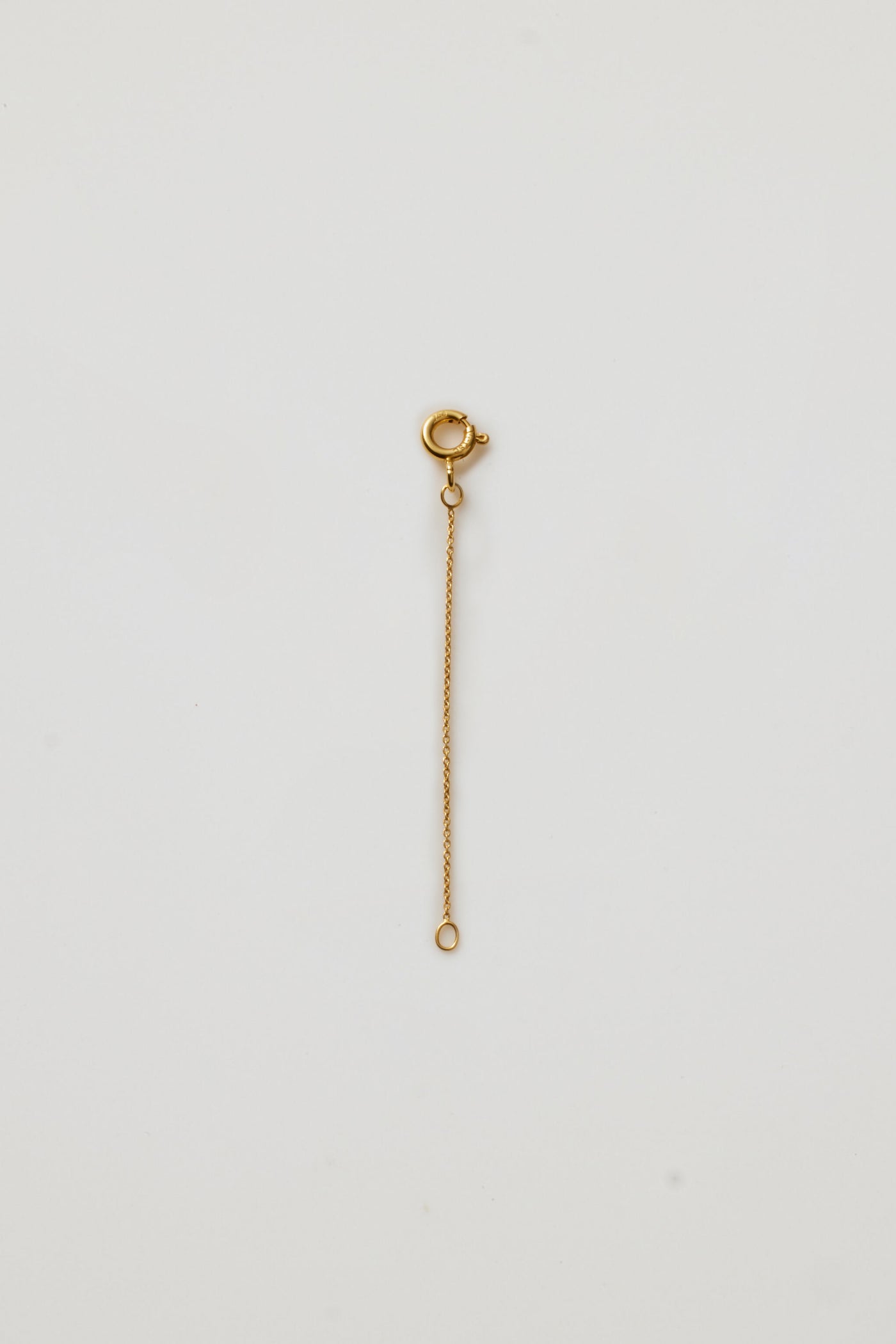 Close-up of an 18k yellow gold chain extender clasp for fine necklaces, designed to lengthen adjustable chains Verse Fine Jewellery