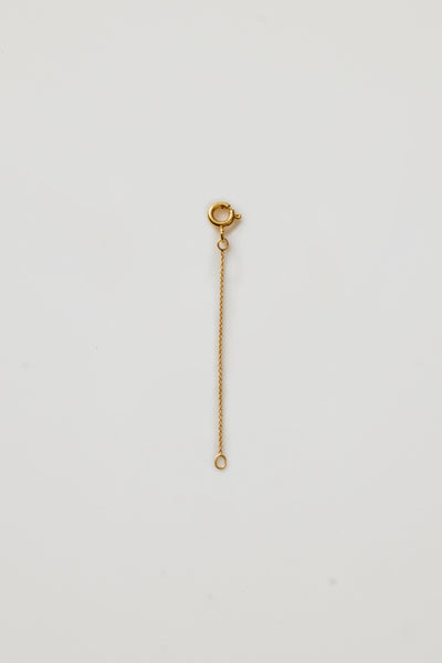 Close-up of an 18k yellow gold chain extender clasp for fine necklaces, designed to lengthen adjustable chains Verse Fine Jewellery
